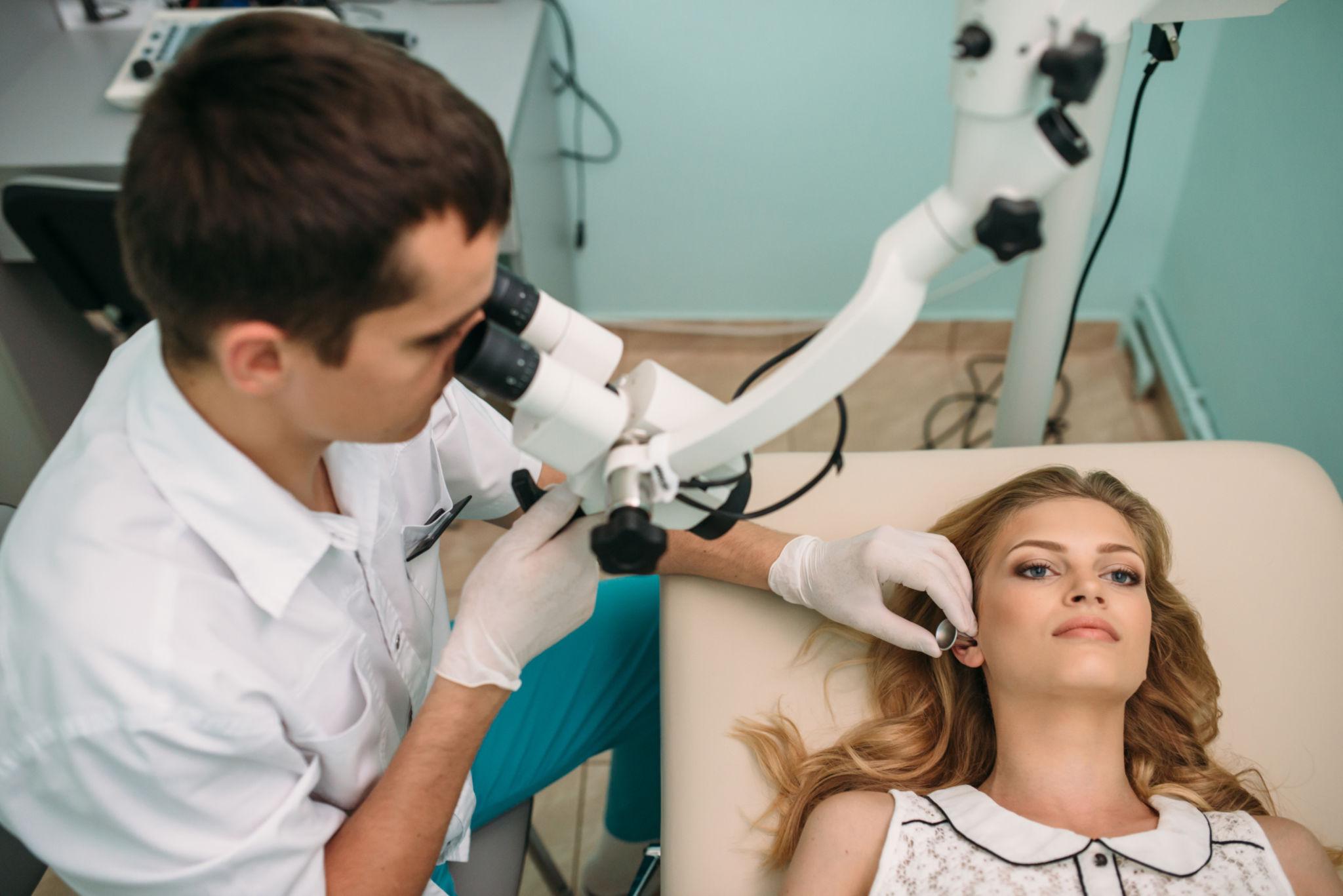 ENT specialist performing microscopic ear examination